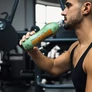 Edzőtermi edzés közben Absolute Live kreatin + L- glutaminos sportitalt fogyasztó sportoló